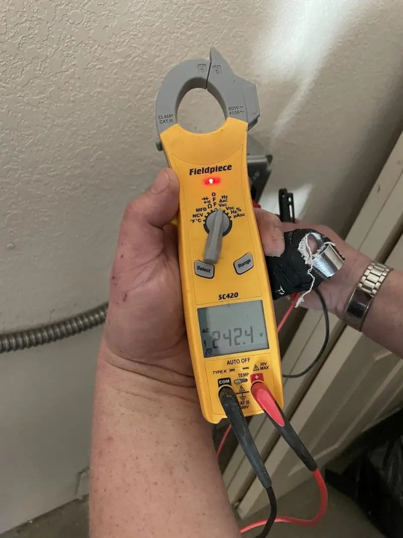 Voltage testing with clamp meter during Recessed Lighting Installation in Fenton